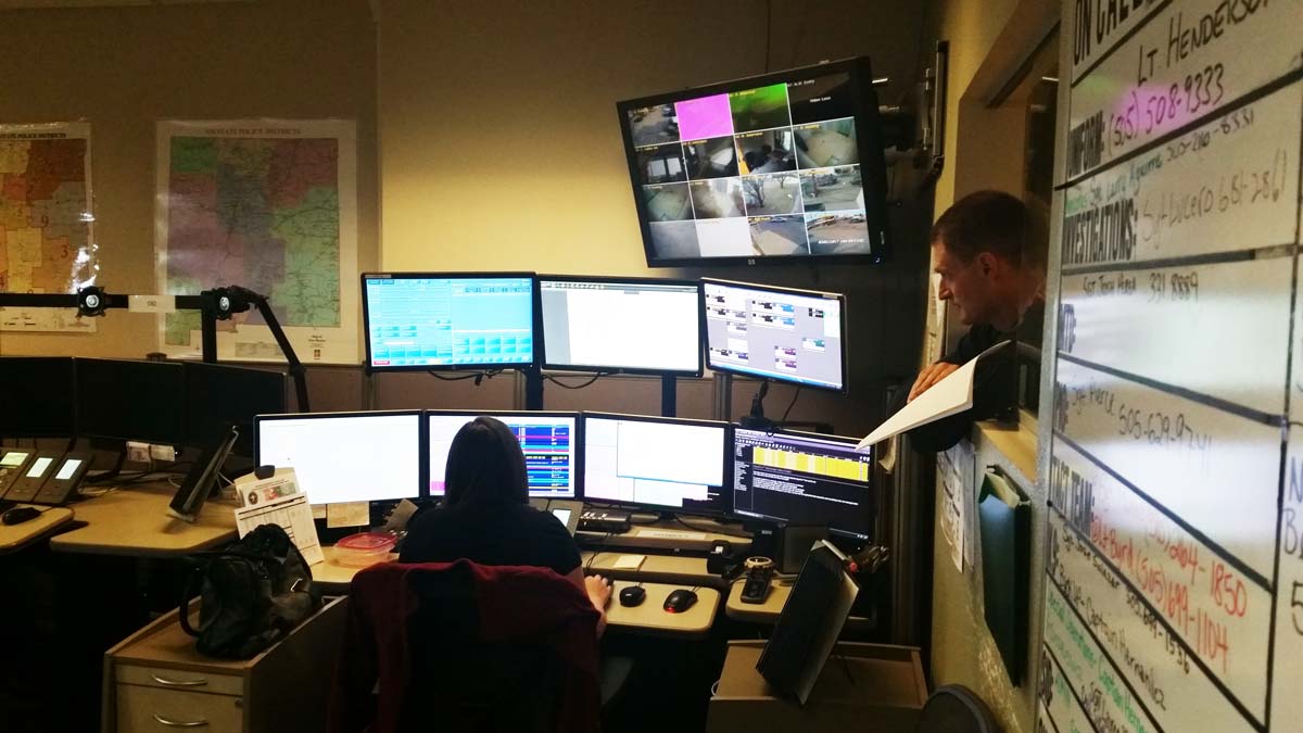 Dispatch image 1 Woman sitting at desk with multiple monitors while someone oversees