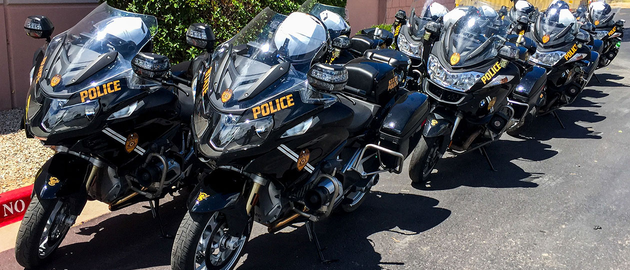 A line of black motorcycles marked State Police parked next to curb