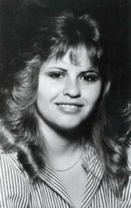 Black and white photo of woman with feathered hair